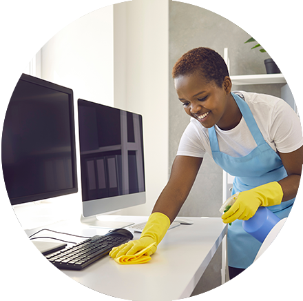 Young woman smiles as she performs commercial cleaning services in office building.